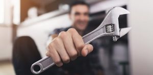A mechanic holding a wrench